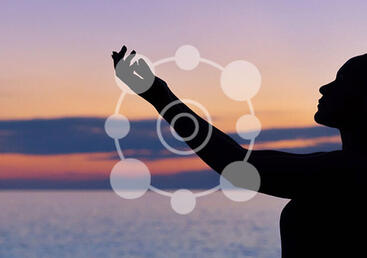 person with eyes closed and  hands in the air during sunset